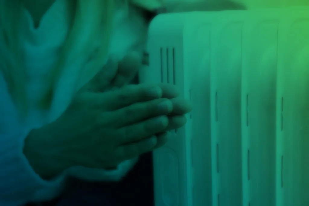 heating-season-woman-warms-her-hands-with-heater